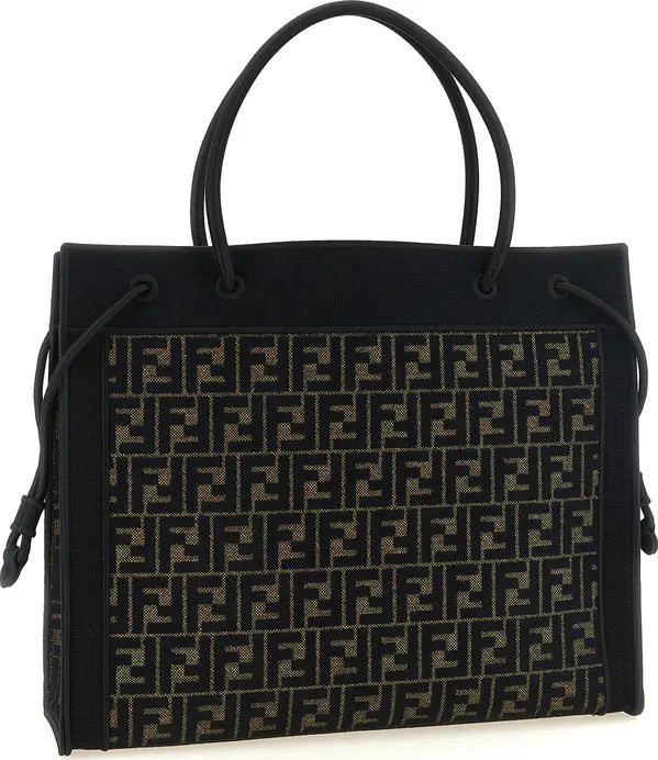 A black Fendi tote bag featuring the signature Zucca monogram pattern in black and beige across the front panel, with black leather top handles and side drawstrings, shown against a plain white background.