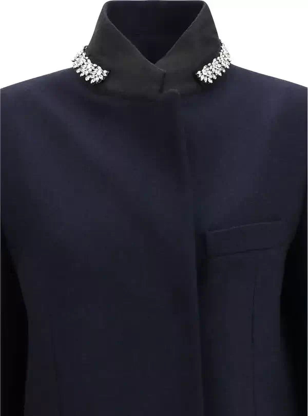 A close-up of a dark navy blue traditional jacket with a high collar decorated with sparkling silver rhinestone embellishments on both sides.