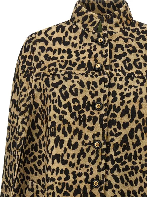 A close-up of a leopard print button-up shirt jacket with a high collar and gold-tone buttons, shown on a white background.