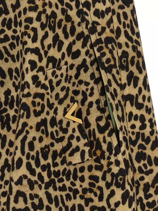 Leopard print fabric with a gold button on a beige background