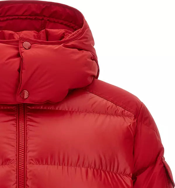 Close-up of a red puffer jacket showing the hood with snap buttons, zipper, and quilted chest panel on a white background.
