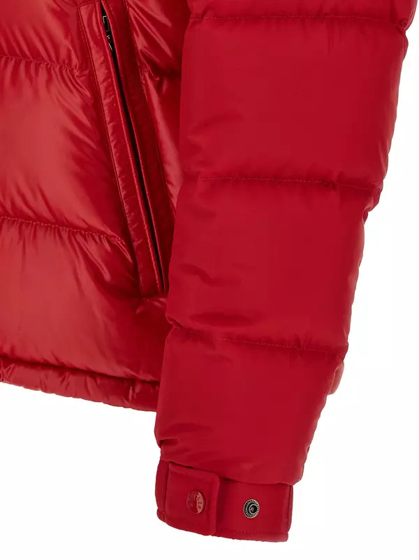 Close-up of a bright red puffer jacket sleeve with horizontal quilting, a black zipper, and a cuff with snap closures on a white background.