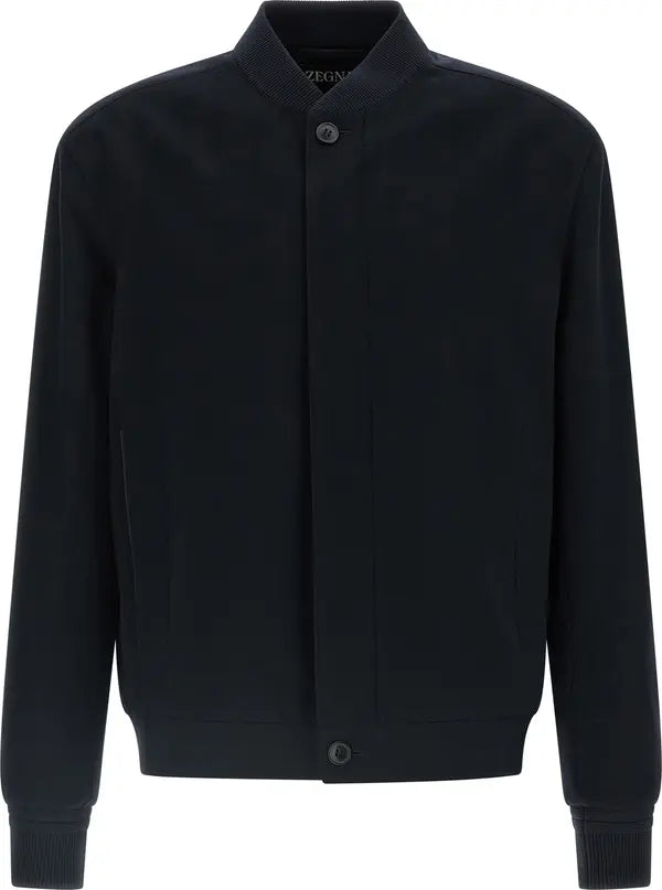 A blue long-sleeve button-up jacket with a stand-up collar, ribbed cuffs, and a ribbed hem, shown against a plain white background.