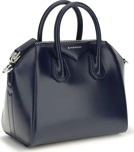 A navy blue Givenchy Antigona handbag with dual top handles, a structured leather body, and silver-tone hardware, shown on a plain white background.