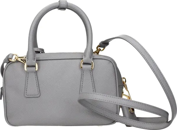 A light gray textured leather handbag with double top handles, a detachable shoulder strap, and gold-tone hardware, shown against a plain white background.