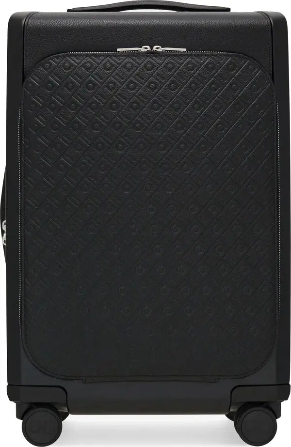 A black hard-shell suitcase with a diamond-quilted embossed pattern on the front panel, featuring a top handle and four spinner wheels.