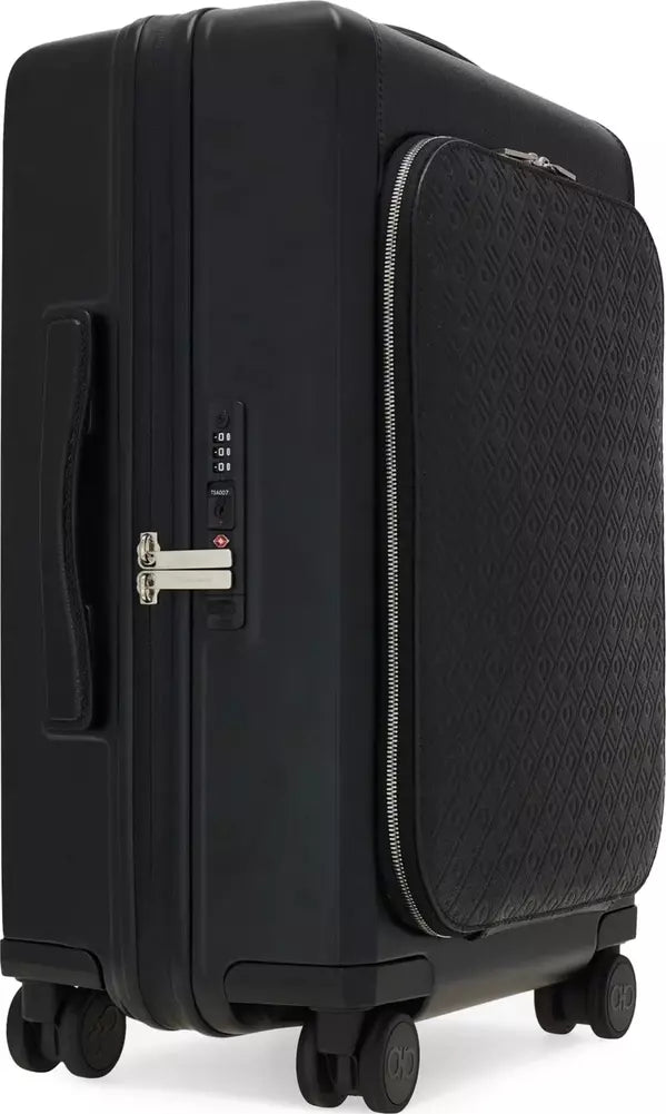 A black hard-shell suitcase with a textured front zippered pocket, four spinner wheels, and a combination lock, shown on a plain white background.