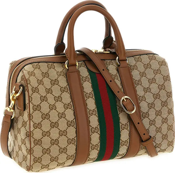 Gucci monogram canvas duffel bag with brown leather handles and trim, featuring the signature green and red web stripe on the front and gold-tone hardware.