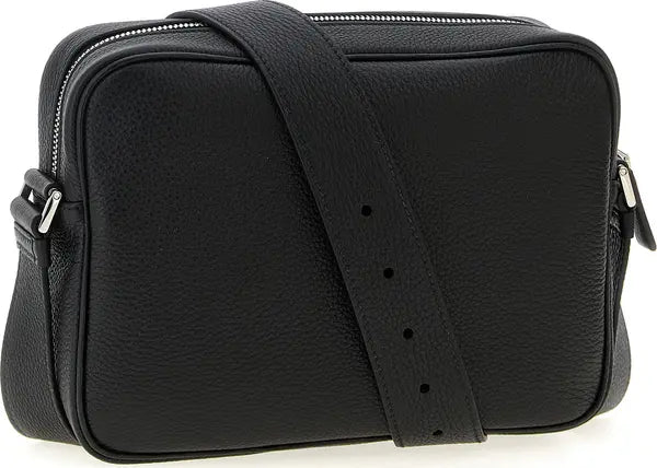 Black textured leather crossbody bag with a matching adjustable shoulder strap, silver-tone zipper, and side buckles, shown on a white background.
