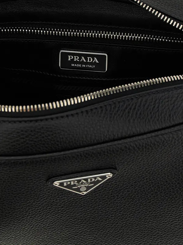 Close-up of a black Prada bag with visible branding.