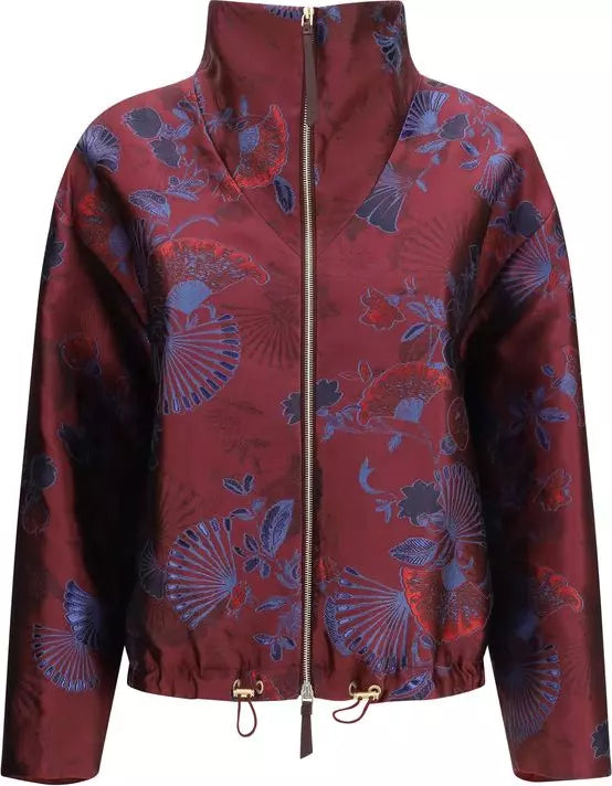 A cropped zip-up jacket with a high stand collar, featuring a red and blue floral fan pattern on a satin-like fabric, with drawstrings at the hem.
