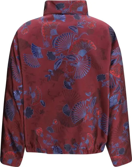 A long-sleeve jacket with a high collar, featuring an all-over pattern of stylized folding fans and floral motifs in blue, purple, and red on a dark red base.