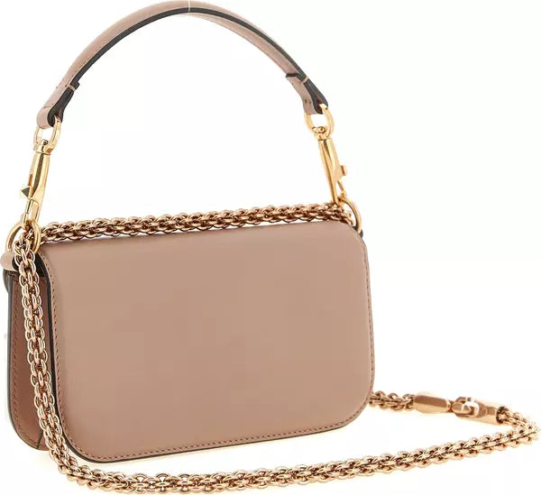 A structured taupe leather handbag with a gold-tone chain strap and a matching top handle, shown on a clean white background.