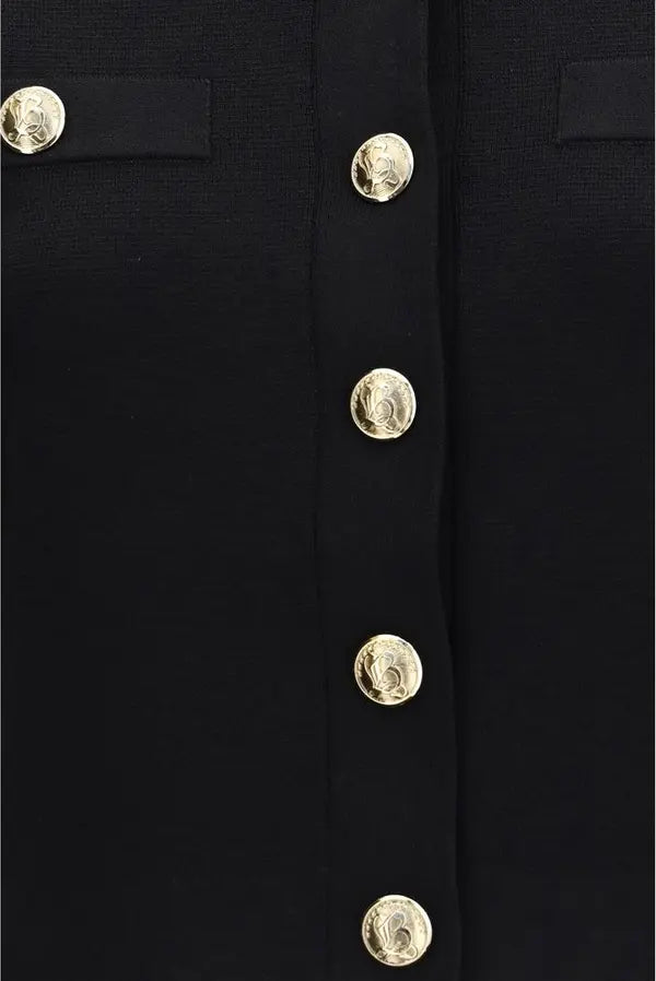 Close-up of a black jacket or coat with a vertical row of round gold-tone buttons and a matching black buttonhole detail on the left side.