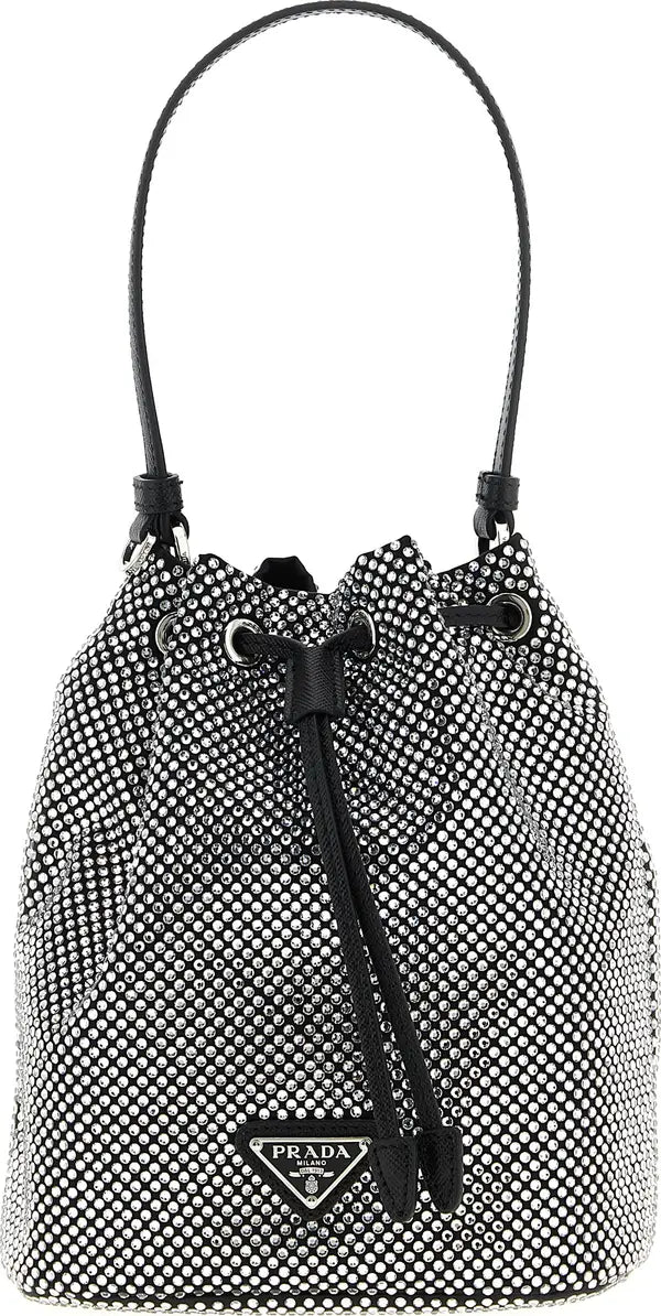 Prada bucket bag in black and white micro-patterned leather with a black leather top handle and drawstring closure.