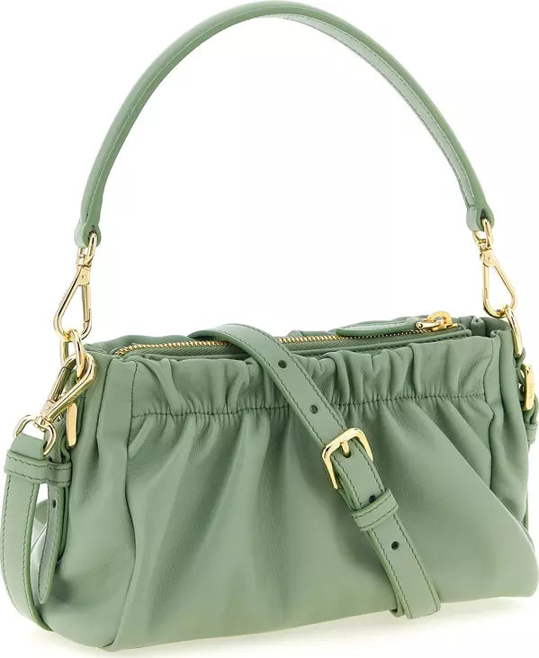 A sage green leather shoulder bag with gold-tone hardware, featuring a top handle, a detachable shoulder strap with a buckle, and a gathered top zip closure, shown on a plain white background.