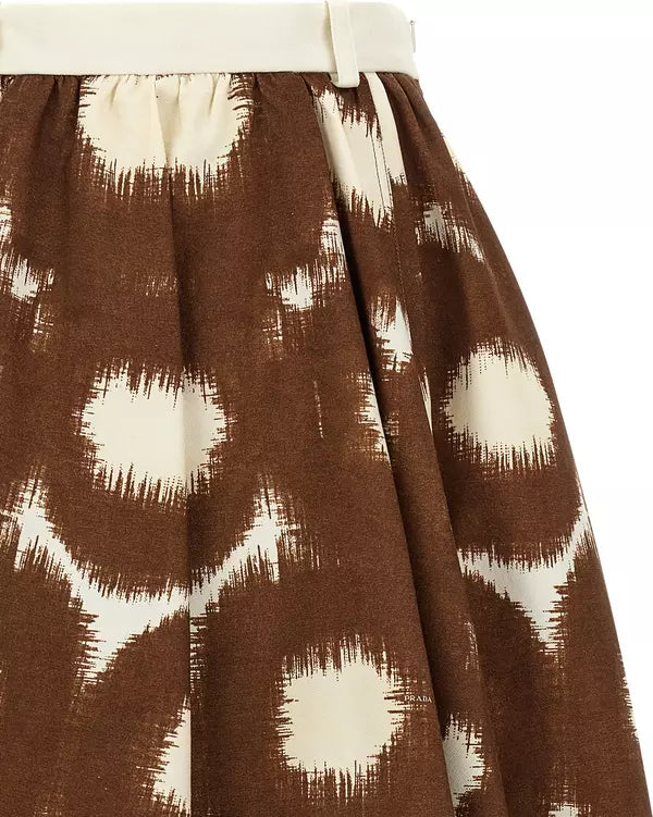Close-up of a brown and cream ikat-patterned skirt with a white waistband.