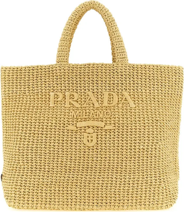 A light beige woven straw tote bag with &