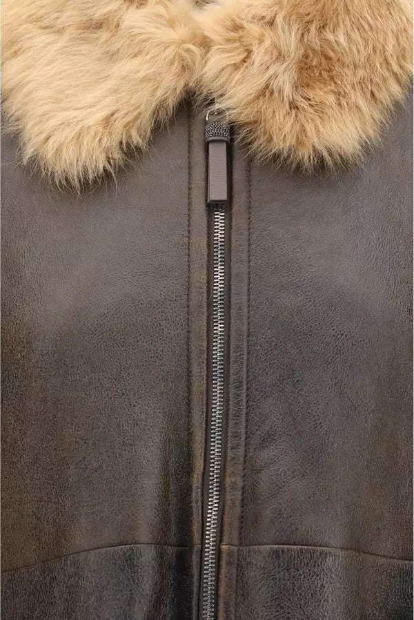 Close-up of a dark brown leather jacket featuring a thick, fluffy light brown fur collar and a central silver zipper.