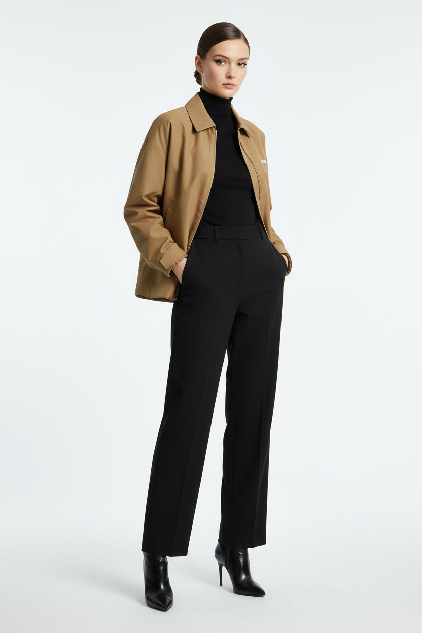 A tan Miu Miu zip-up jacket with a pointed collar, featuring the brand name &