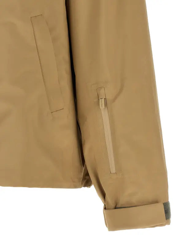 Close-up of a beige jacket with a pocket on a white background