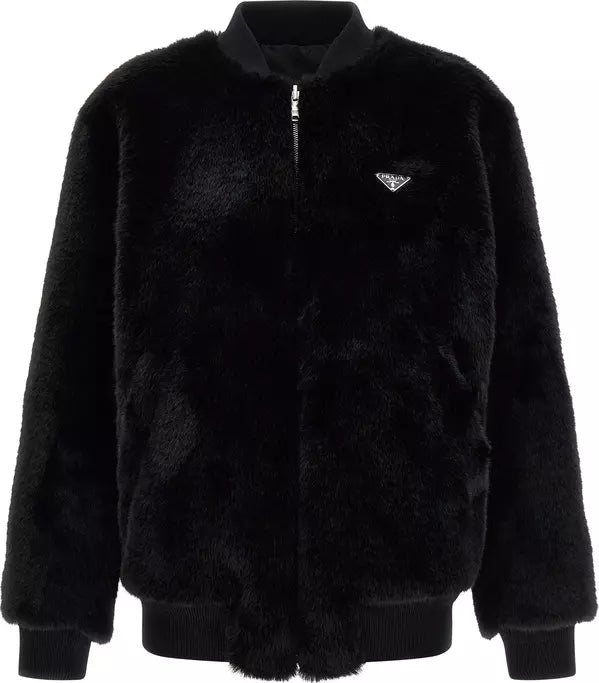 A black sherpa fleece zip-up jacket with a small silver Prada logo on the chest, displayed on a clean white background.