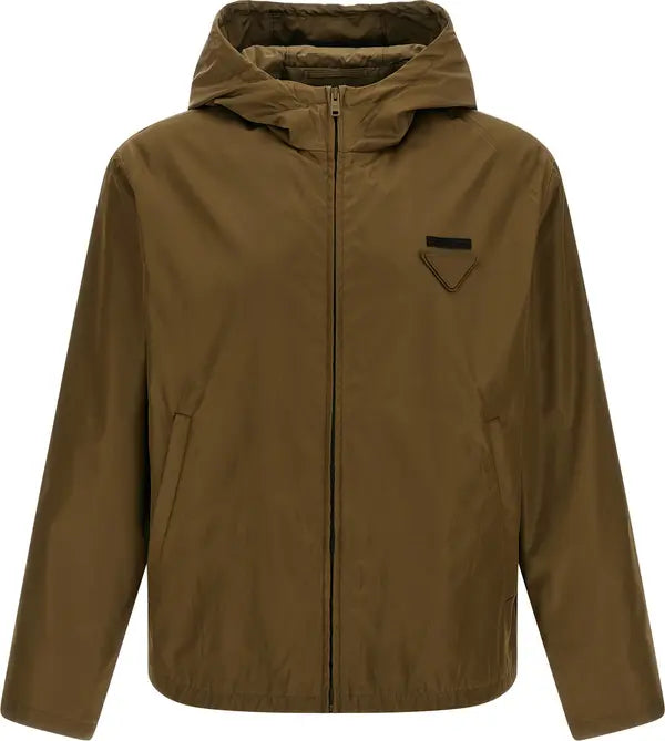 A hooded zip-up jacket in a solid olive-brown color, featuring a small black triangular patch on the left chest, displayed on a clean white background.