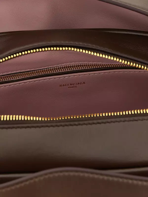 Balenciaga Bowling Le 7 small brown lamb leather handbag with aged gold-finish metal accents and embossed logo.