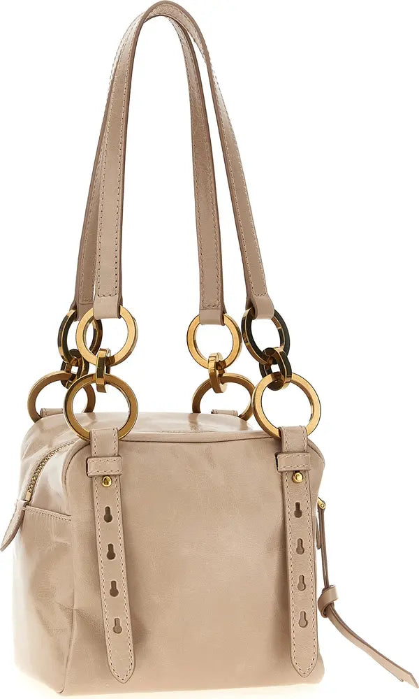 A light beige leather handbag with double shoulder straps and large gold-tone metal rings, shown on a plain white background.