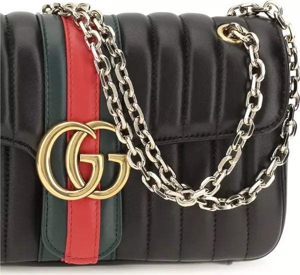 Gucci GG Marmont Jetset medium black matelassé leather shoulder bag with Double G emblem and gold-tone chain strap.