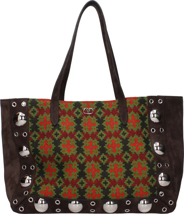 Handbag with a green and red pattern and silver studs on a white background