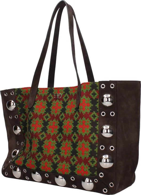 Tote bag with a patterned front and studded details on a white background