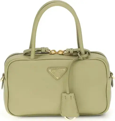 Green handbag with a gold Prada logo on a white background
