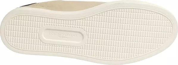 Close-up of the textured white outsole of a slip-on shoe, showing the embossed brand name &