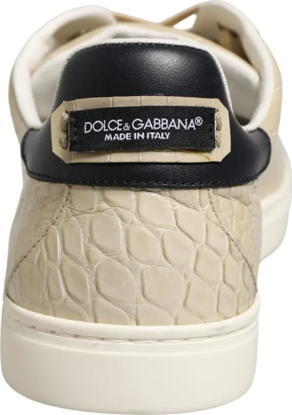 Close-up rear view of a Dolce &amp; Gabbana sneaker featuring a textured beige crocodile-embossed leather upper, a black leather heel tab, and a cream-colored sole.