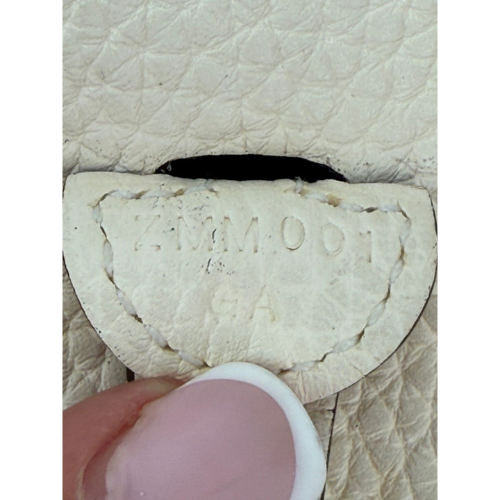 Close-up of a textured beige surface with 'Yum Yum' branding.