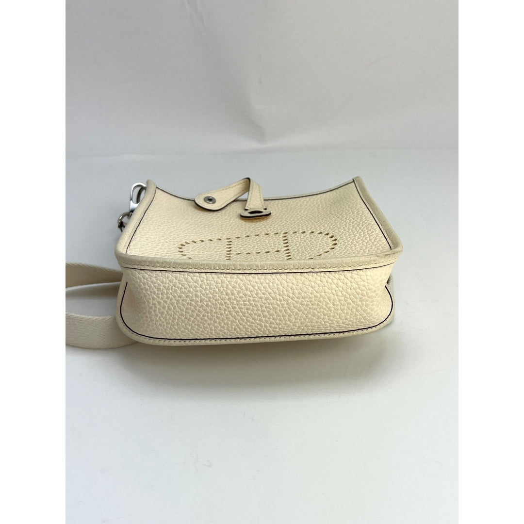 Beige handbag with textured surface on a white background