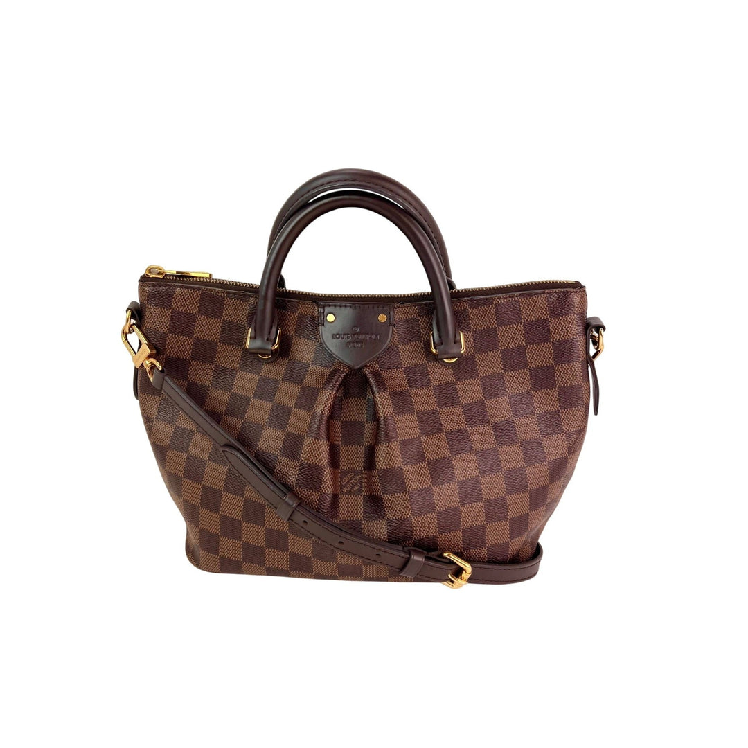 Brown checkered handbag with gold accents on a white background