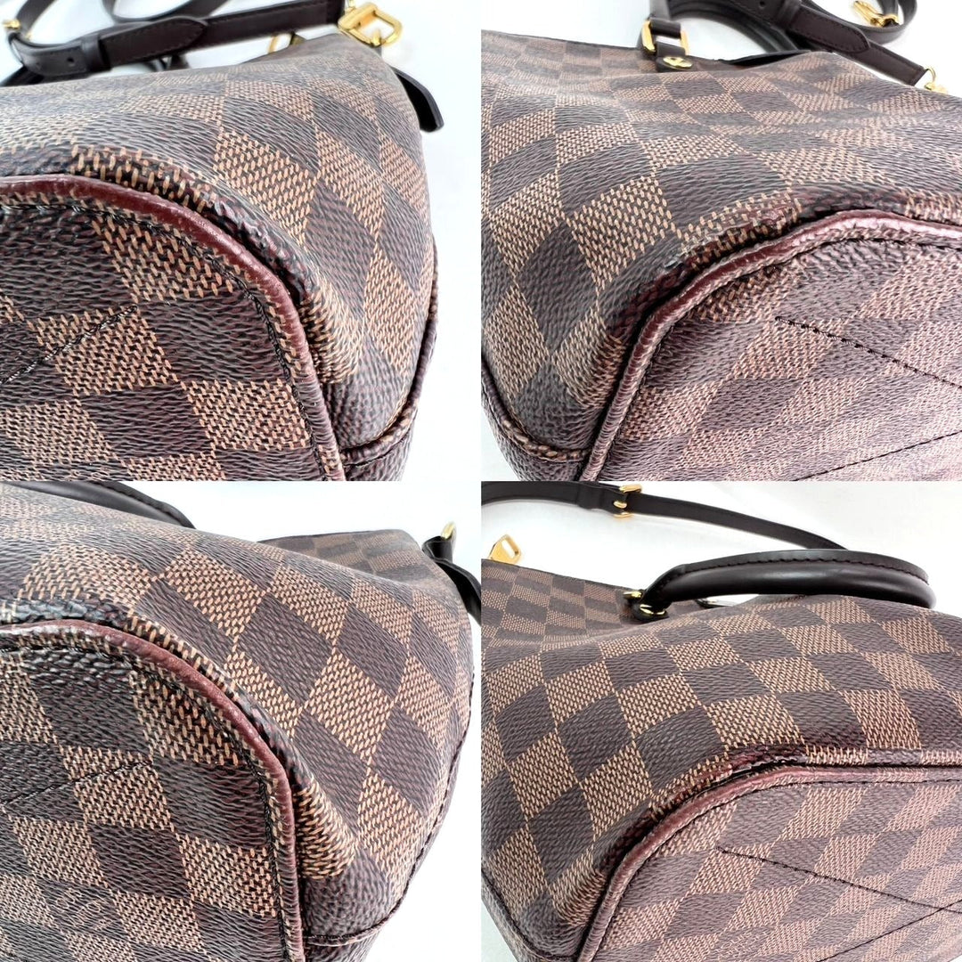 Brown checkered handbag with gold accents on a white background