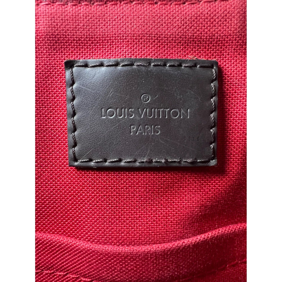 Louis Vuitton label on a red fabric background
