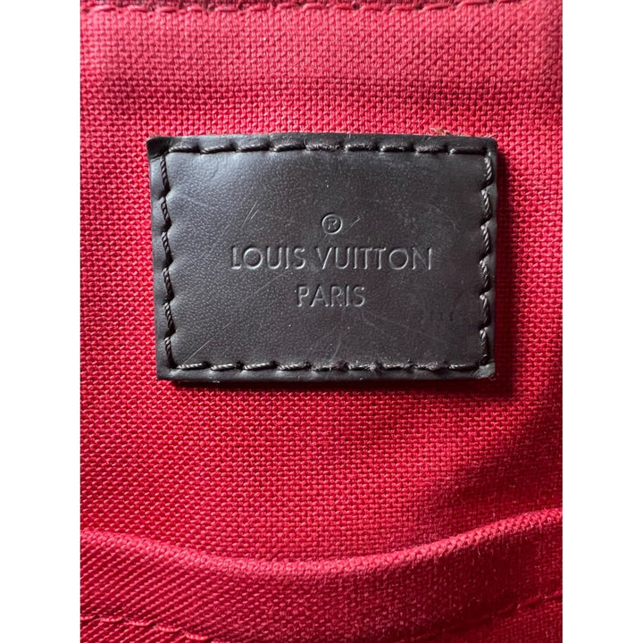 Louis Vuitton label on a red fabric background