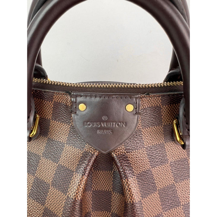 Close-up of a Louis Vuitton handbag with visible brand logo.
