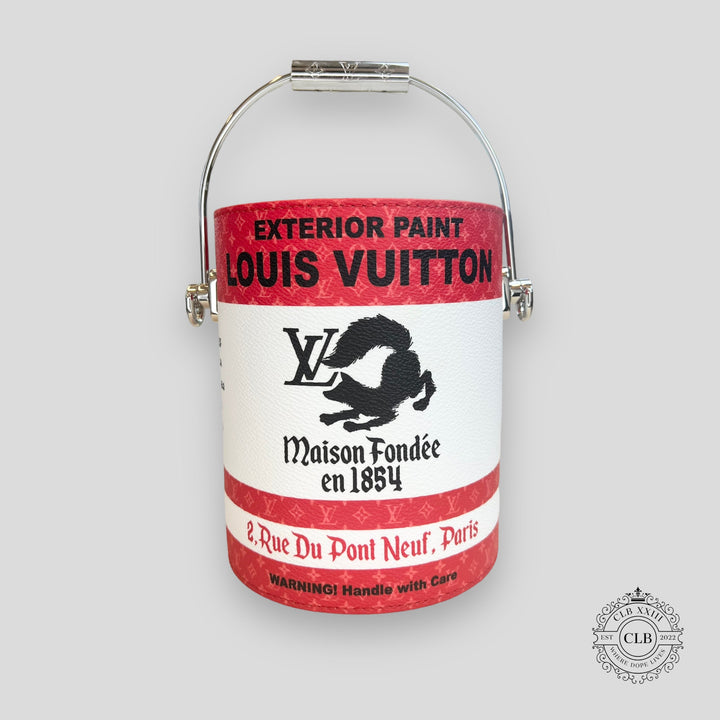 Louis Vuitton paint can with red and white label on a gray background