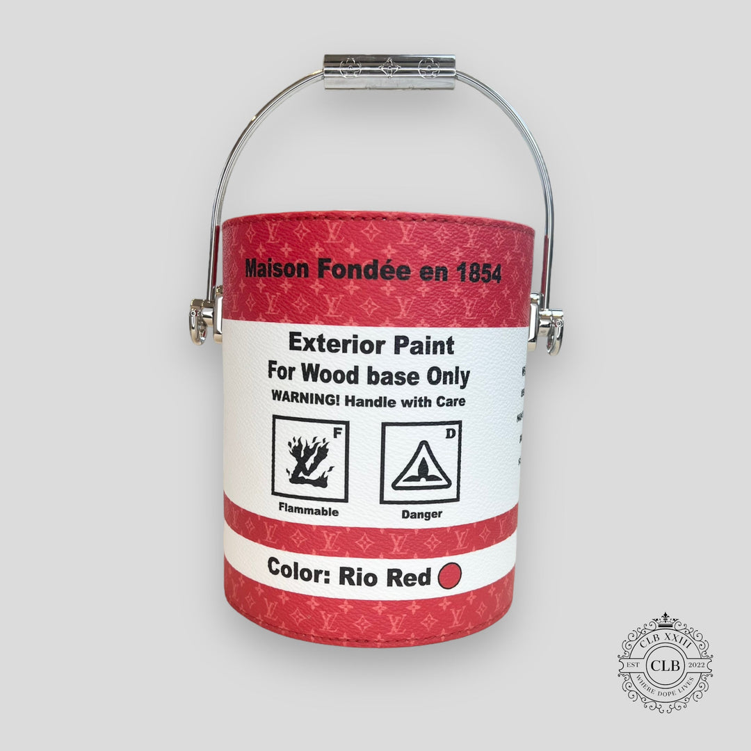 Red paint can with white label on a gray background