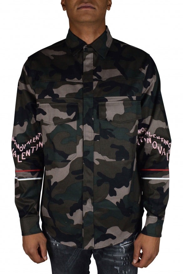 Camouflage shirt with brand text on sleeves worn by a person