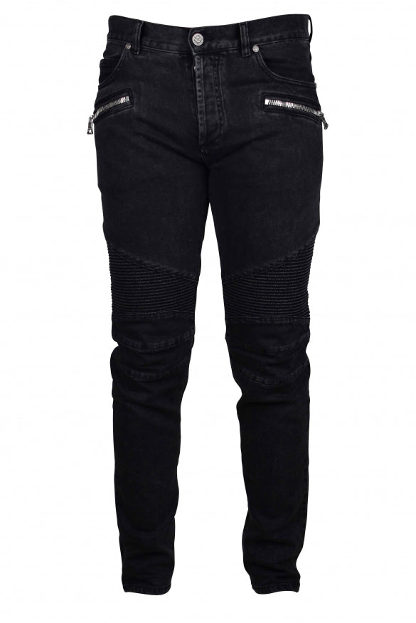 Black jeans with zippers and buttons on a white background