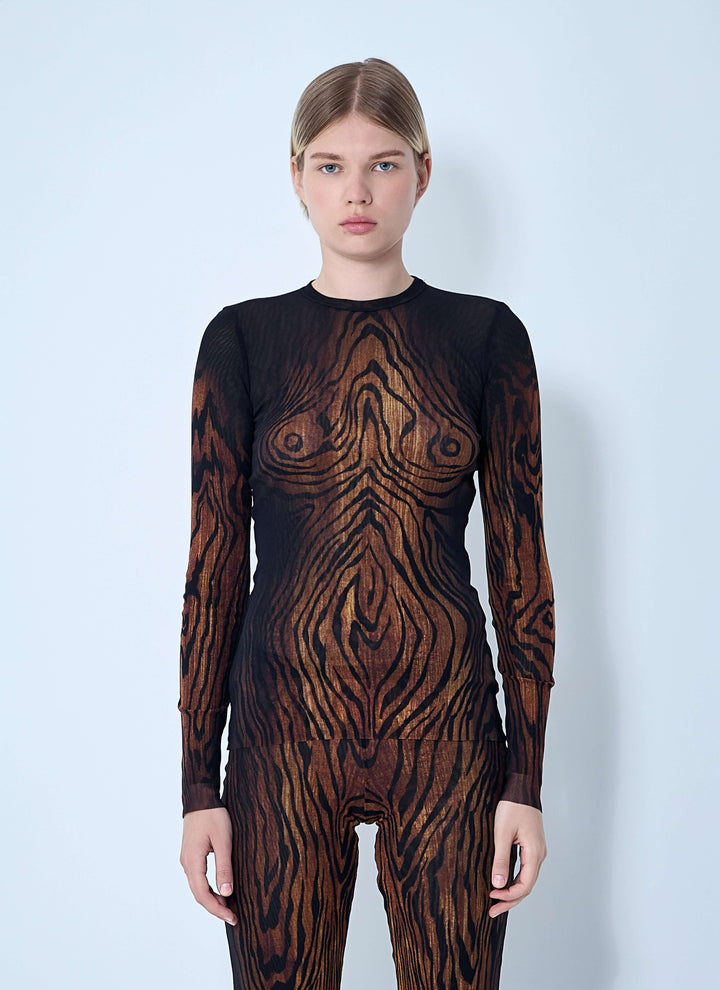 Model wearing a black and brown patterned bodysuit against a light blue background