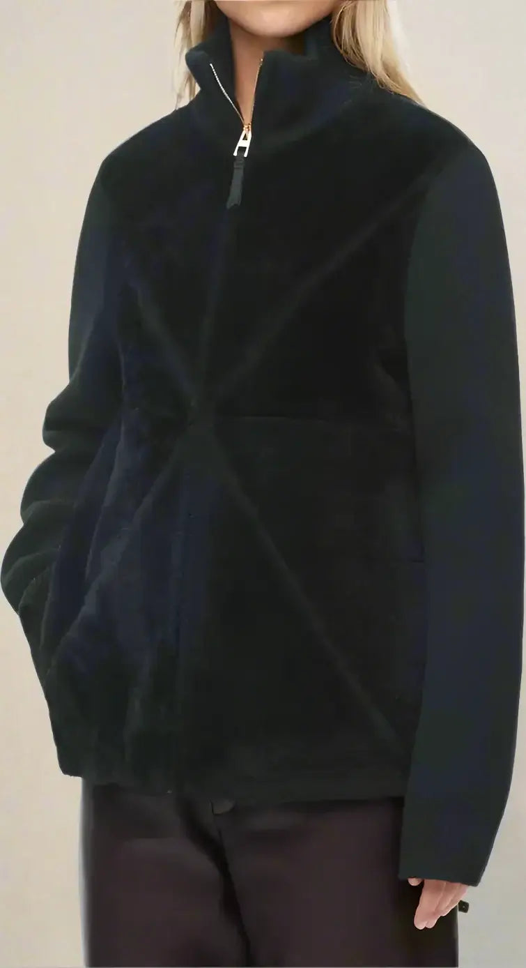 Person wearing a black fleece pullover on a white background