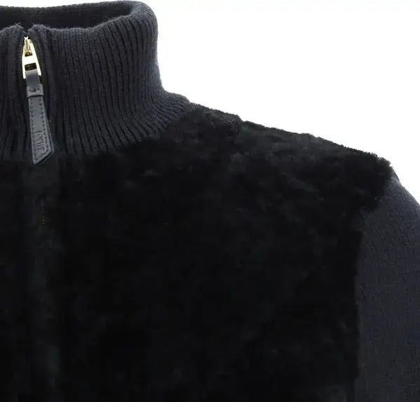 Close-up of a black knit sweater with a zipper detail on a white background