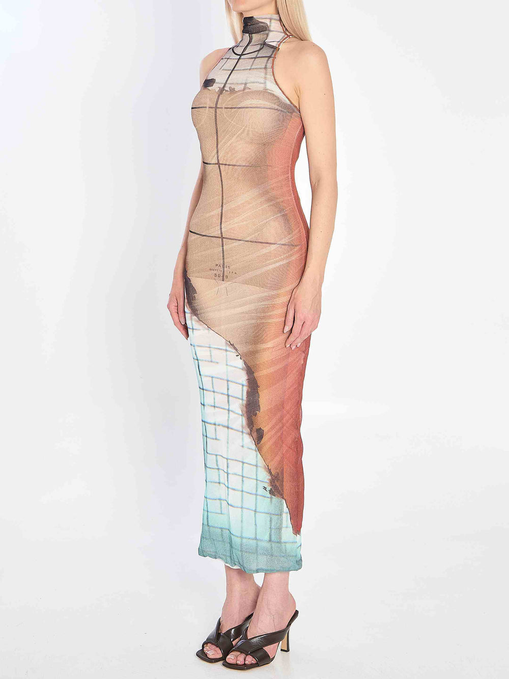 Woman wearing a gradient dress with geometric patterns on a white background